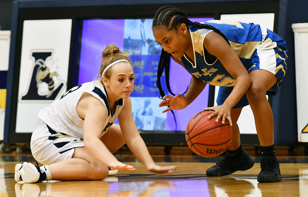 Jet Elia Wright, right, dribbles away from Lee County's Claire Cummings.