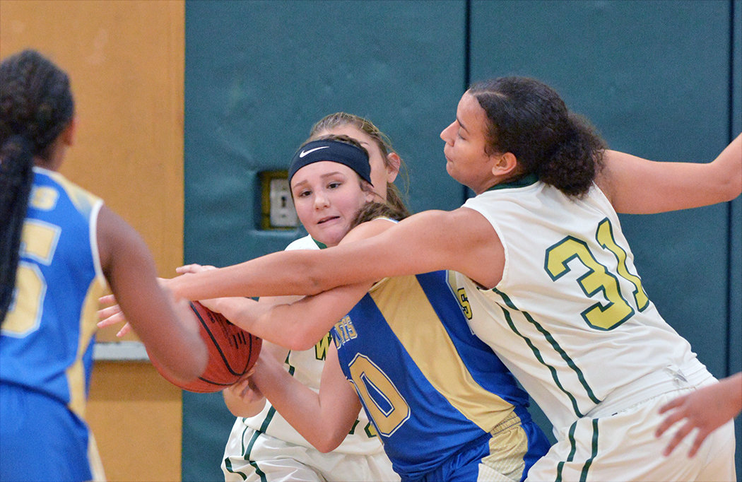 Jet Ashlyn Ray, with ball,  is caught in the middle of Eastern's Tehya Jordan.