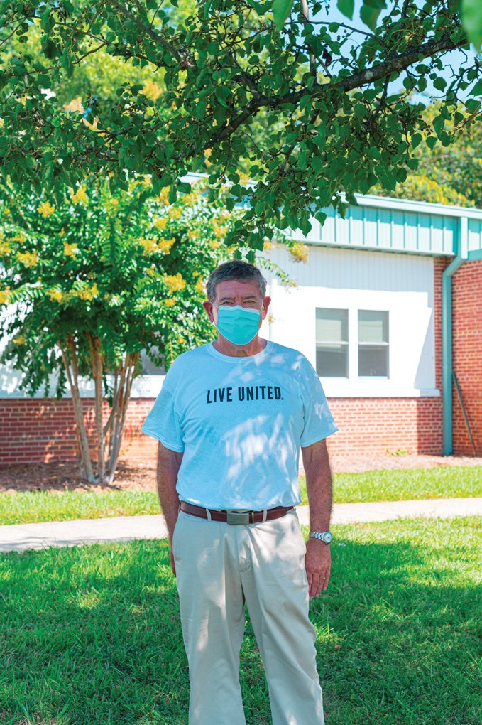 Jim Sink, chairperson of United Way’s board, stands beneath a tree in front of the Wren Center at the Siler Boys and Girls Clubs. He said he enjoys the ‘active service format’ forced this year by the pandemic.