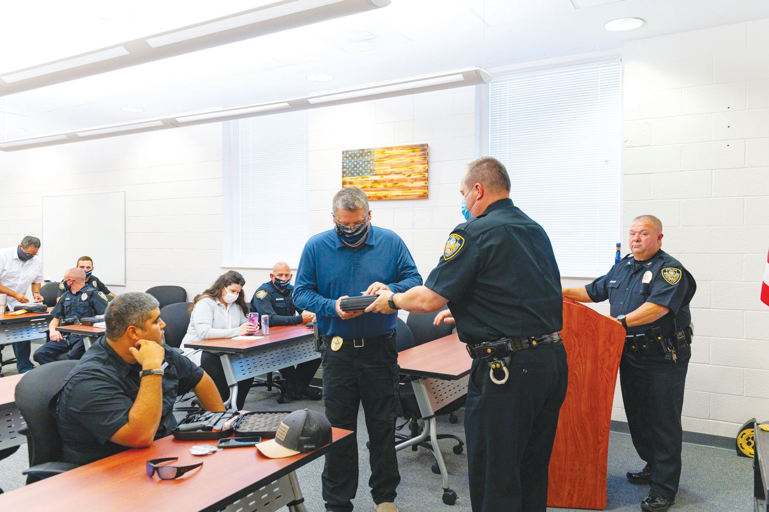 Siler City Chief of Police Chief Mike Wagner, right, watches as his officers accept their new badges last October. The department’s officer staff stands to grow by more than 25% under the town’s proposed budget for fiscal year 2021-22, with plans to nearly double in the next three years, according to Chief Mike Wagner.