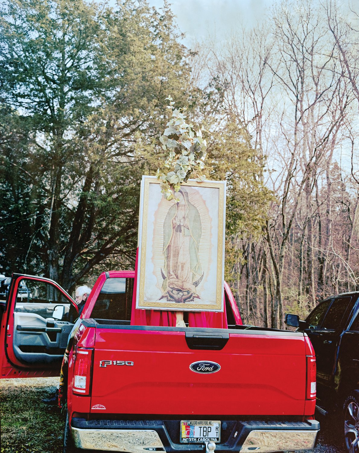 An altar to Mother Mary, the Virgin of Guadalupe, sits in the back of a pickup as to be seen by everyone while driving around.