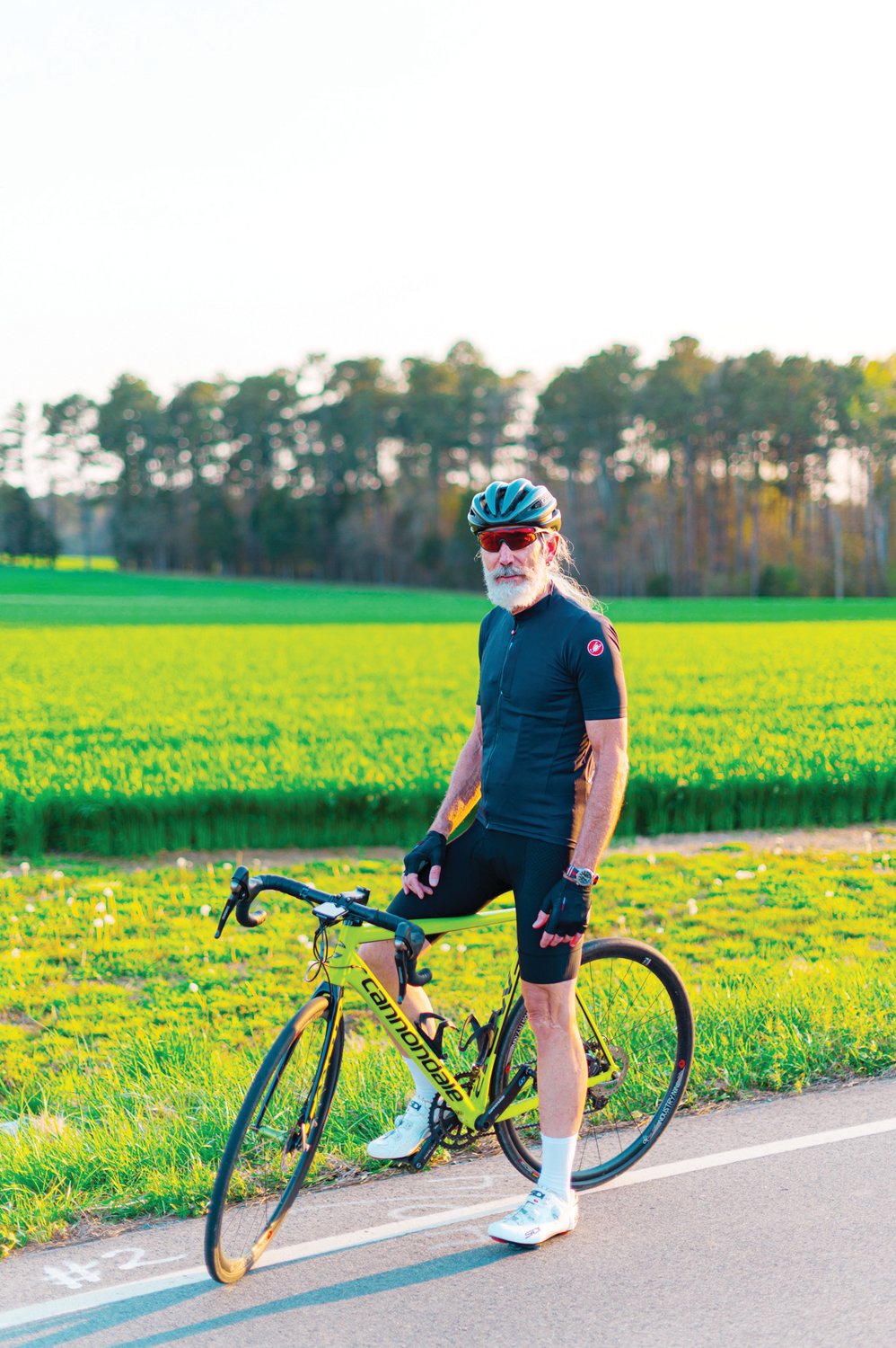Chuck Gillis, 70, poses with his bike in front of a