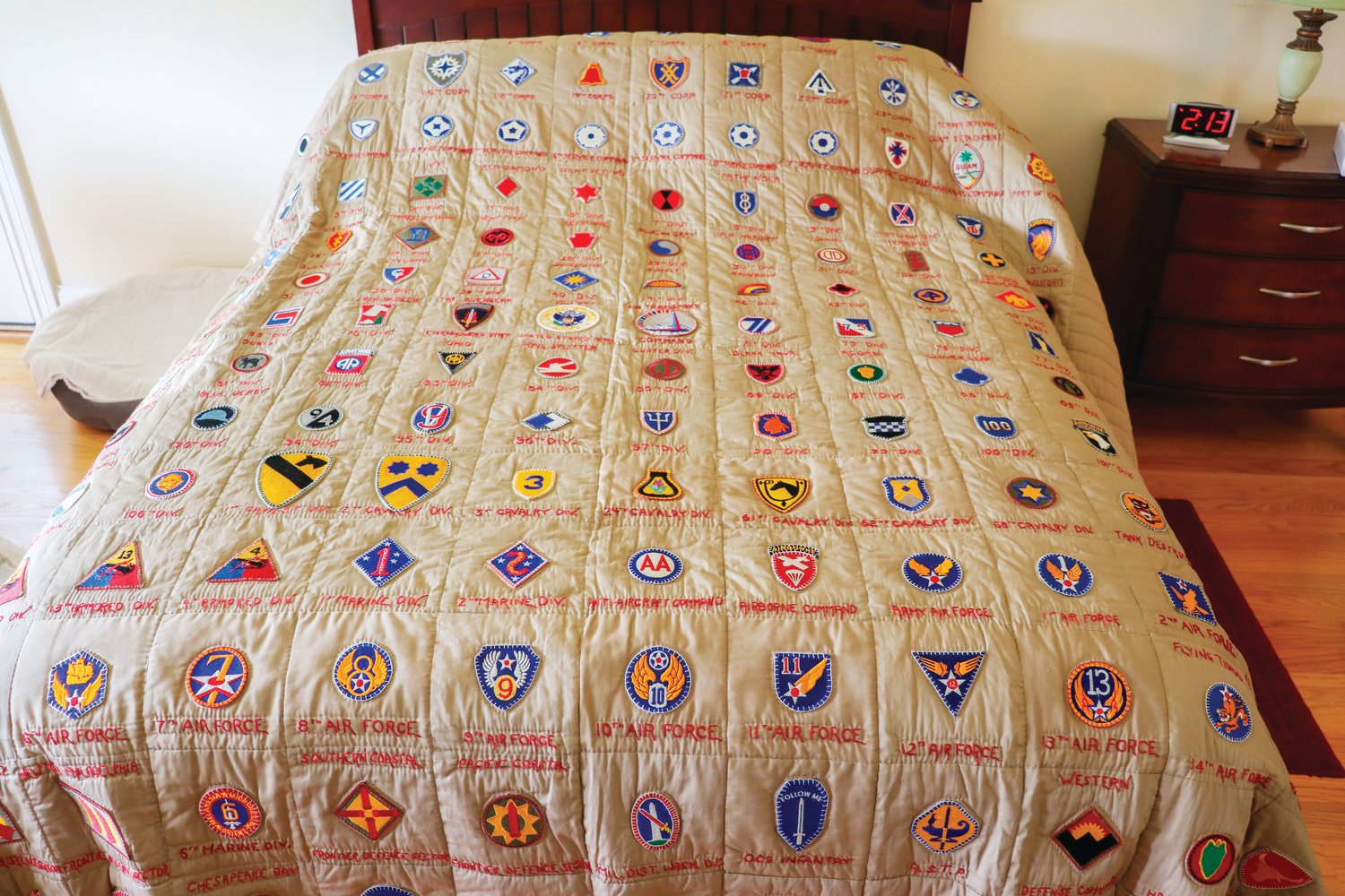 This quilt was made by Wesley Hart's late wife, Agnes. The badges represent units and locations where Hart served during World War II.