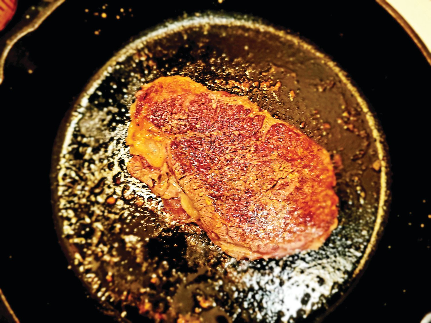 A perfectly-seared steak, just about ready for plating.