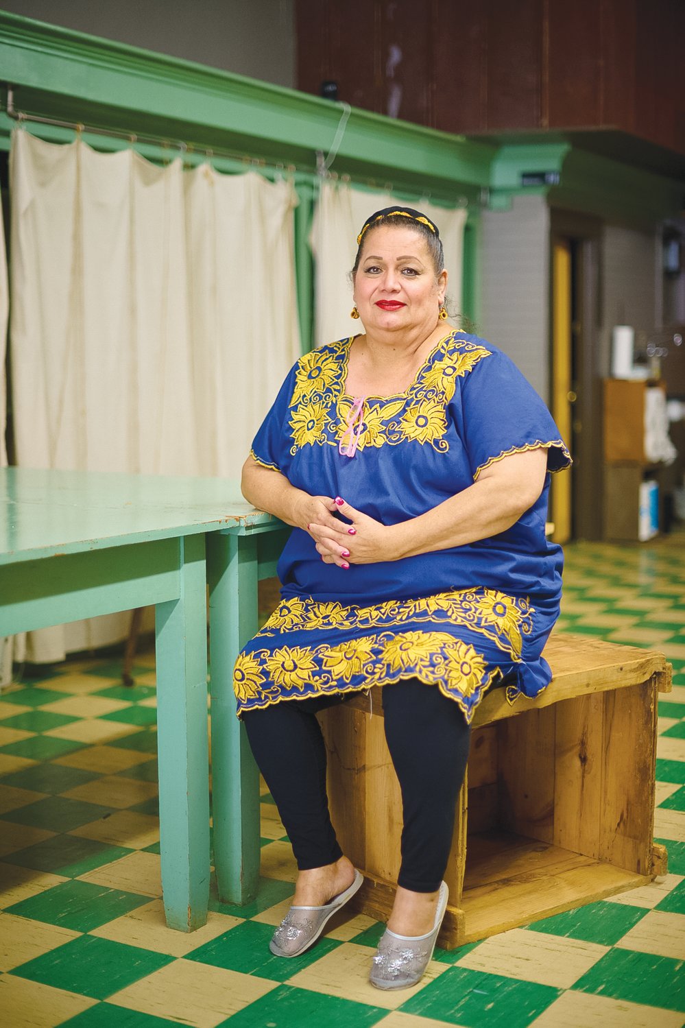 The Hispanic Liaison's Elena González, 62, sits inside The Alliance in downtown Siler City. She goes there most Wednesday mornings for a few hours to study English with her Chatham Literacy tutor, Patty Poe.