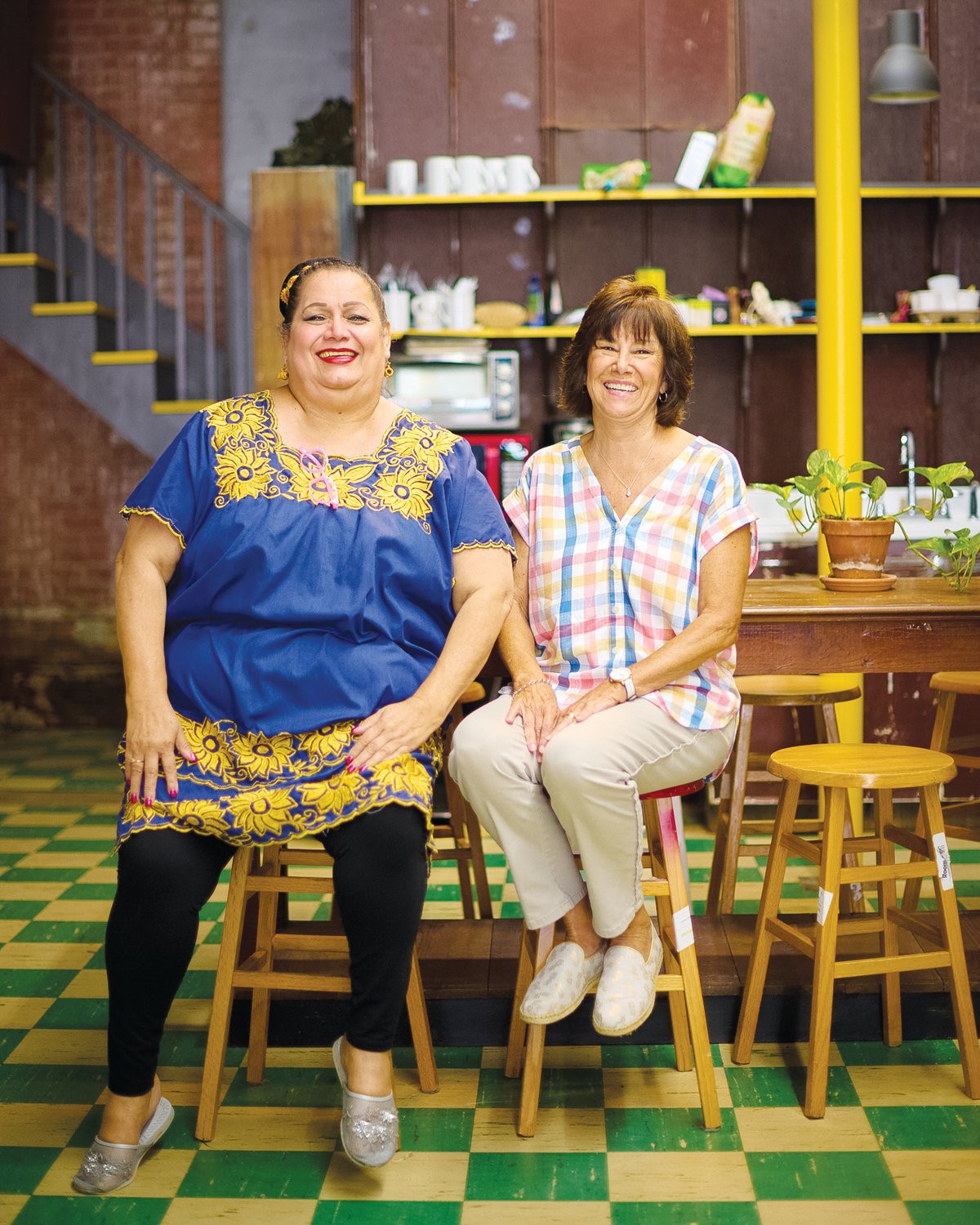 The Hispanic Liaison's Elena González, 62, sits with her Chatham Literacy tutor, Patty Poe (right), inside The Alliance in downtown Siler City. González gathers there most Wednesday mornings for about two hours to improve her English with Poe.