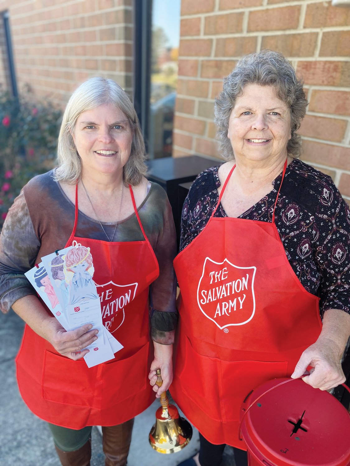Salvation Army of Chatham County Director Rebecca Sommer-Petersen, left, poses with Jane Wrenn as the two — along with Donna Smith — prepare for a busy holiday season.