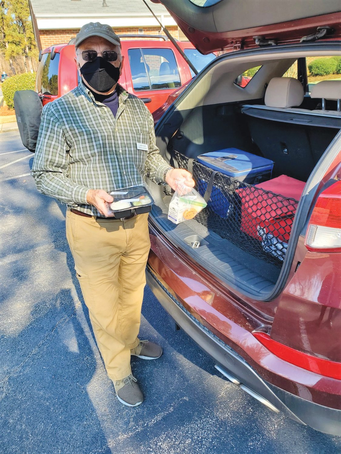 Volunteer driver Larry Ross makes a stop during a Meals on Wheels delivery.