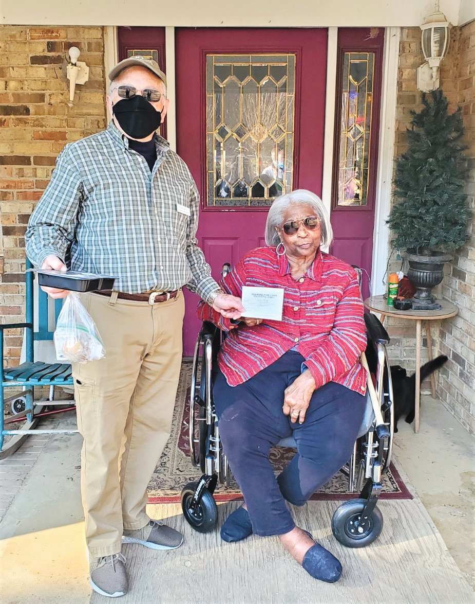 Larry Ross delivers a meal to Meals on Wheels recipient Mary Reaves.