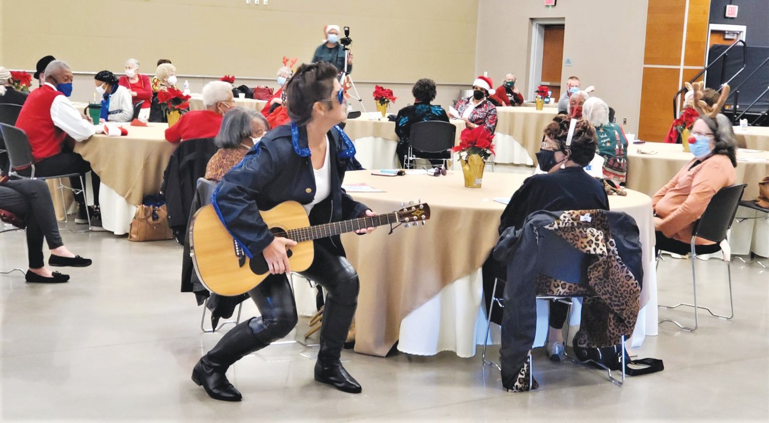 Jackie Green plays Elvis at the Council on Aging's holiday party.