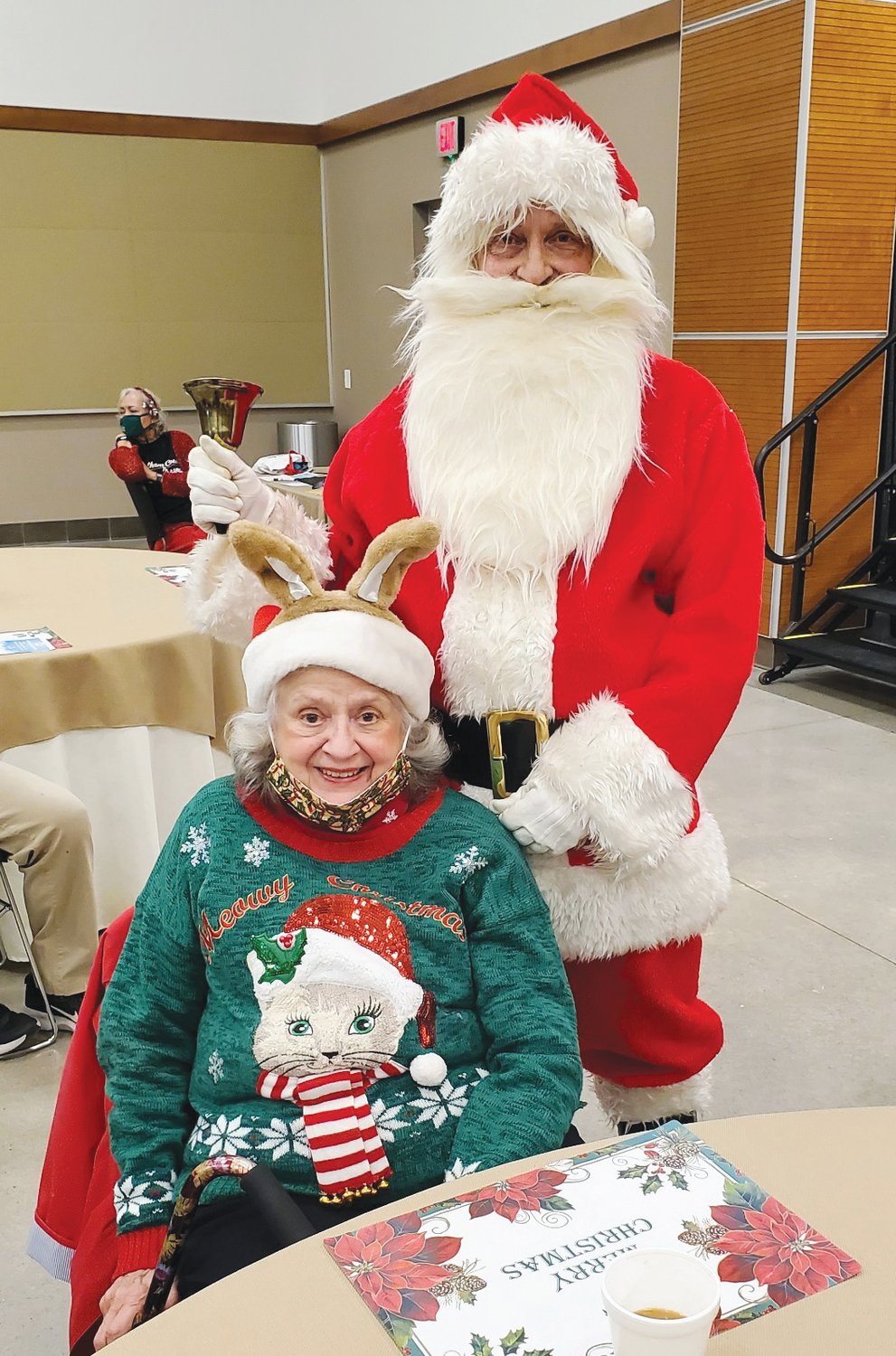Council on Aging Director  Dennis Streets portrays Santa, posing with Mary Lou Mackintosh.