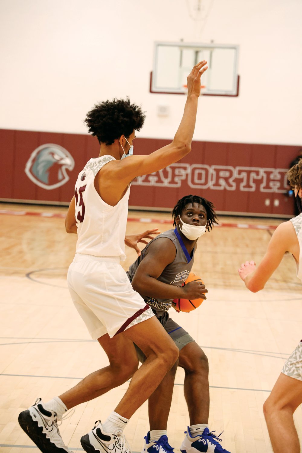 Jordan-Matthews senior Rayshaun Alston (with ball) looks to go up for a shot against Seaforth sophomore Jarin Stevenson in the Jets' triple-overtime loss, 70-61, to the Seaforth Hawks last Friday in Pittsboro. Alston was the Jets' leading scorer on the night with 29 points.
