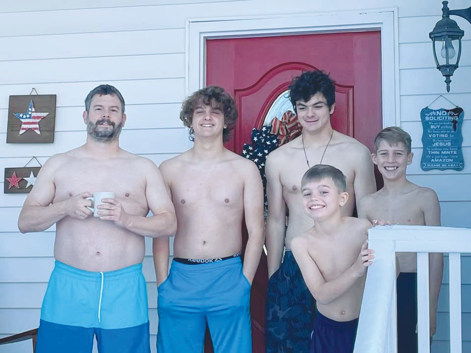 Tammy Trotter's husband and twins, plus two young family friends, prepare to make snow angels in their swimming trunks after snow fell for the second time in Chatham County last weekend.