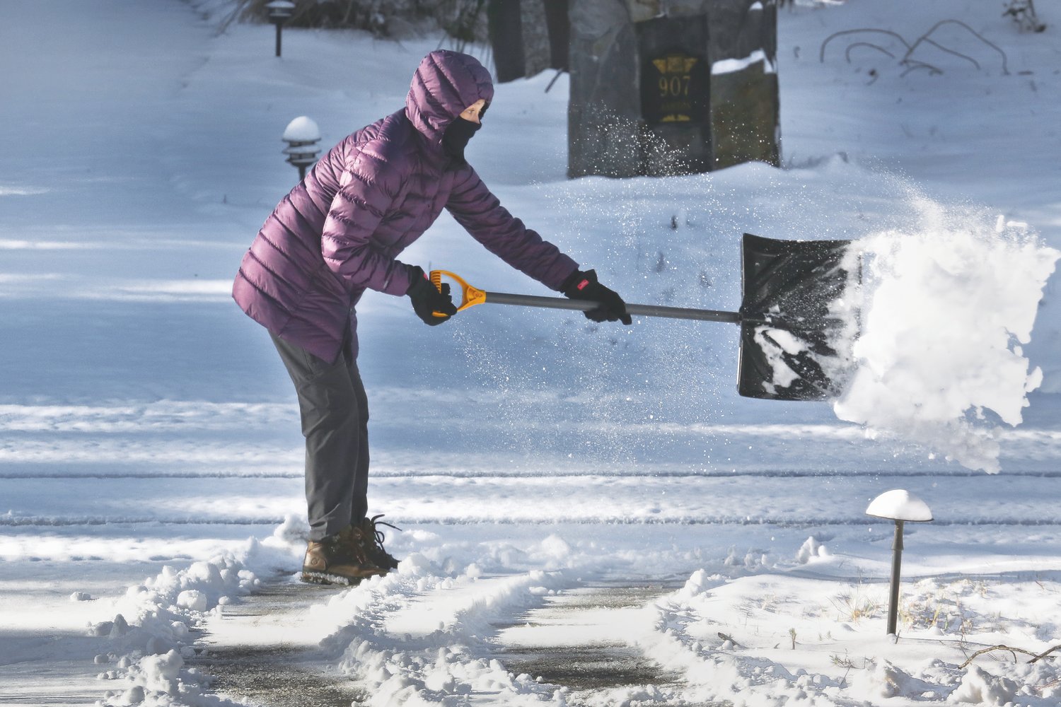 News + Record contributing photographer Ed Lallo got this action shot — of his wife, Adrienne, shoveling the driveway at the couple's home in Fearington Village.
