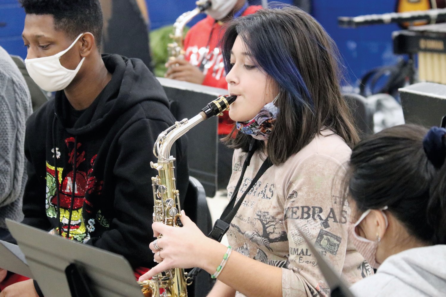 Clara Rojas plays the saxophone during an afternoon workshop led by La Fiesta Latin Jazz Sextet last Friday inside J-M.