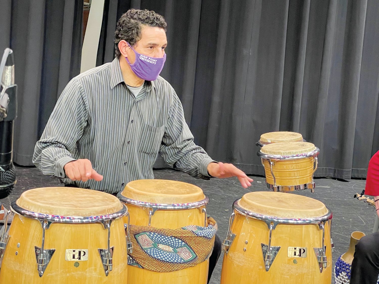 Drummer Ramon Ortiz of La Fiesta Latin Jazz Sextet teaches student percussionists about playing Latin jazz with fellow band member Beverly Botsford on Jan. 28 in Jordan-Matthews High School. Ortiz is originally from the Dominican Republic.