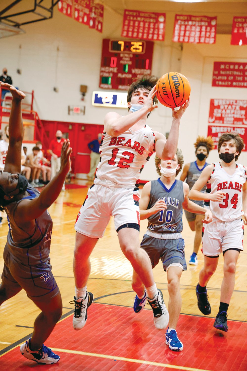 Chatham Central senior Colin Lagenor (12) weaves through the air to put up a floater in the Bears' 69-41 win over the Jordan-Matthews Jets last Friday. Lagenor (16 points) is one of the team's veteran leaders, accoding to Head Coach Robert Burke, who praised Lagenor's ability to fight in the paint against bigger competition.