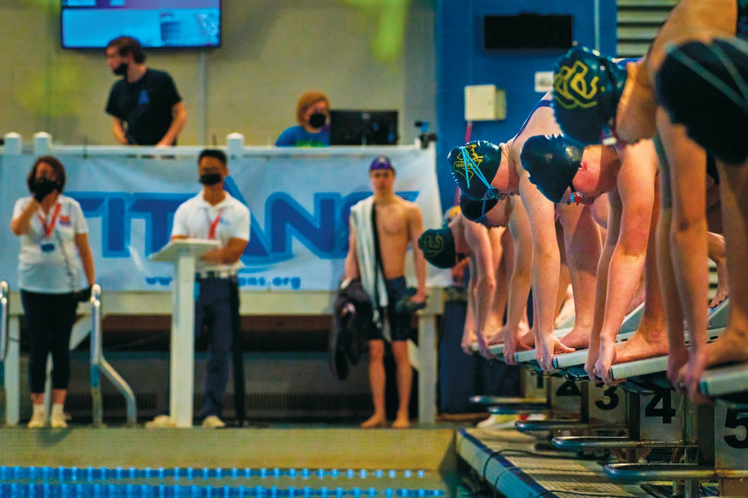 Northwood freshman Abby Emrich (center right, in Northwood cap) prepares to dive into the pool during the women's 100-yard butterfly at the NCHSAA 3A Swimming State Championships at Triangle Aquatic Center last Friday. Emrich placed 5th in the championship final with a time of 59.57.