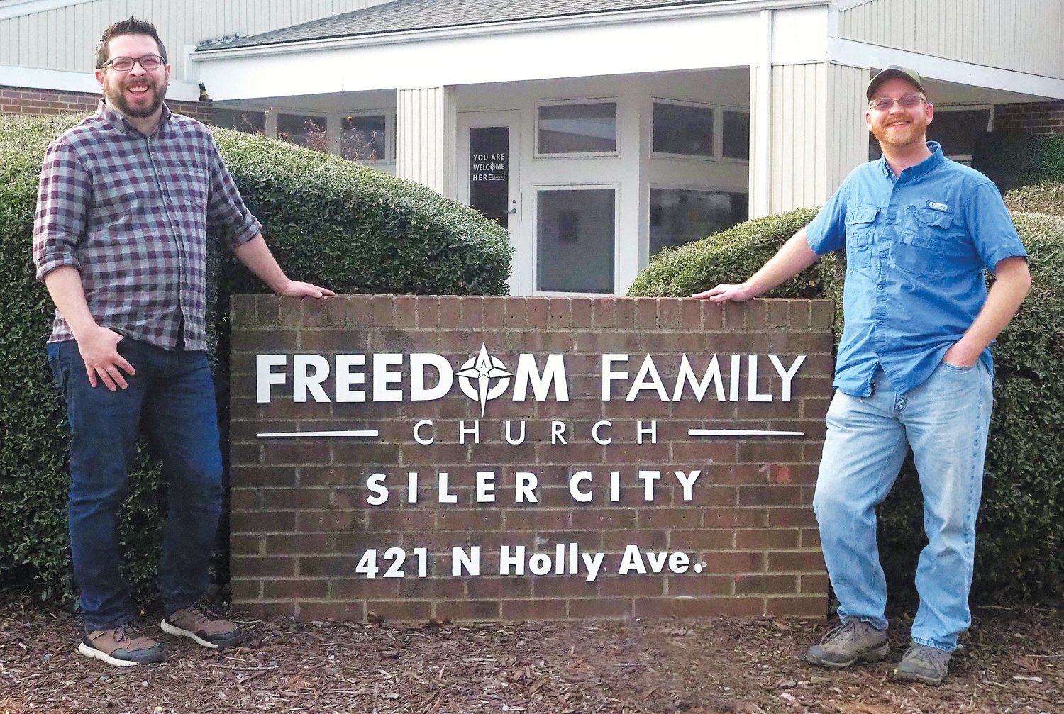 Love Chatham's executive director, Dakota Philbrick (right), stands outside Freedom Family Church in Siler City with the church's pastor, Ben Suggs, who's also a founding member of Love Chatham.