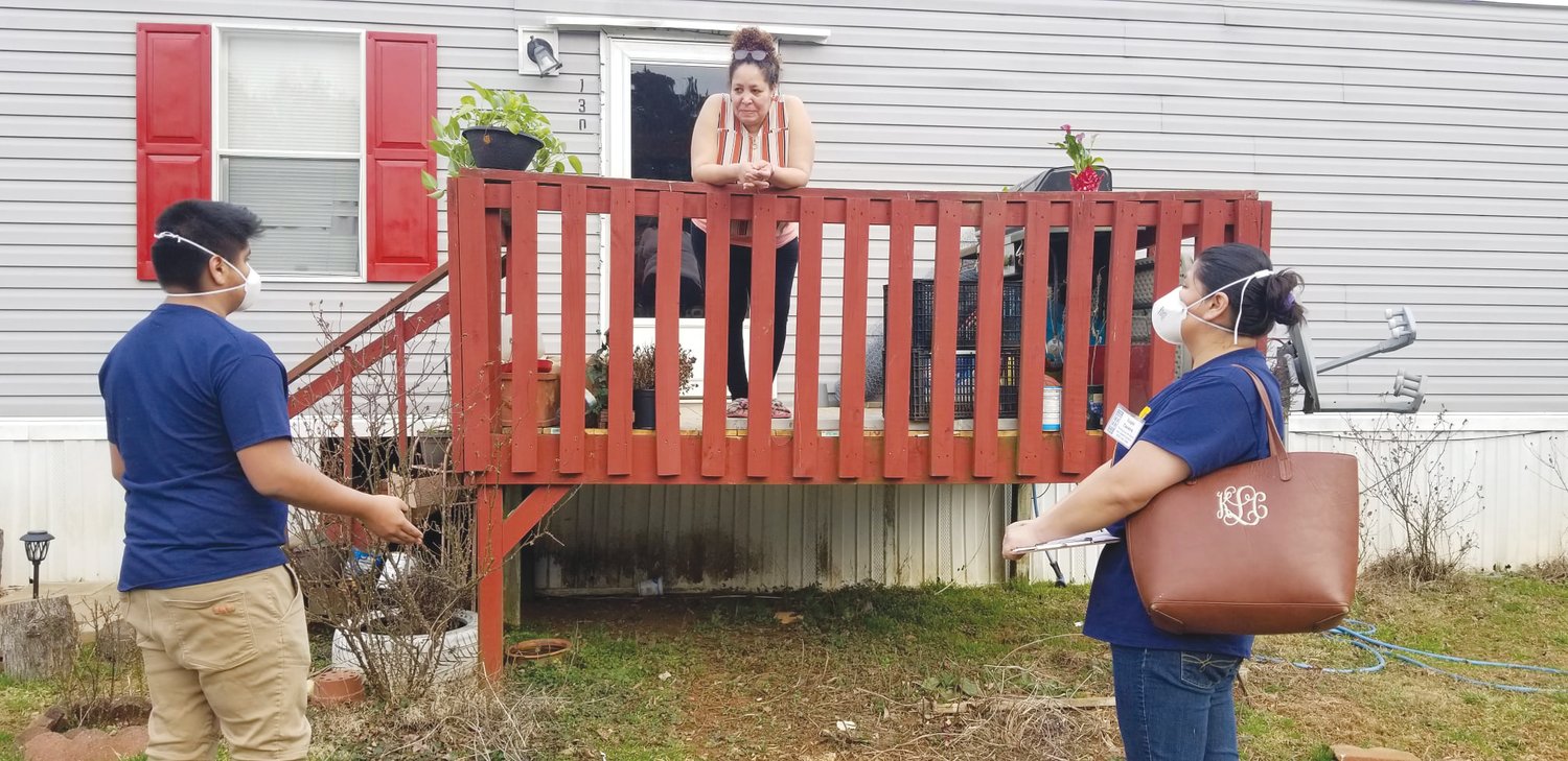 COVID-19 Lay Health Advisors Lupe Tavera and Ervin Martinez, her son, begin knocking on neighbors' doors in late February in Santa Fe Circle in Siler City. They are also responsible for Country Living Mobile Home Park.