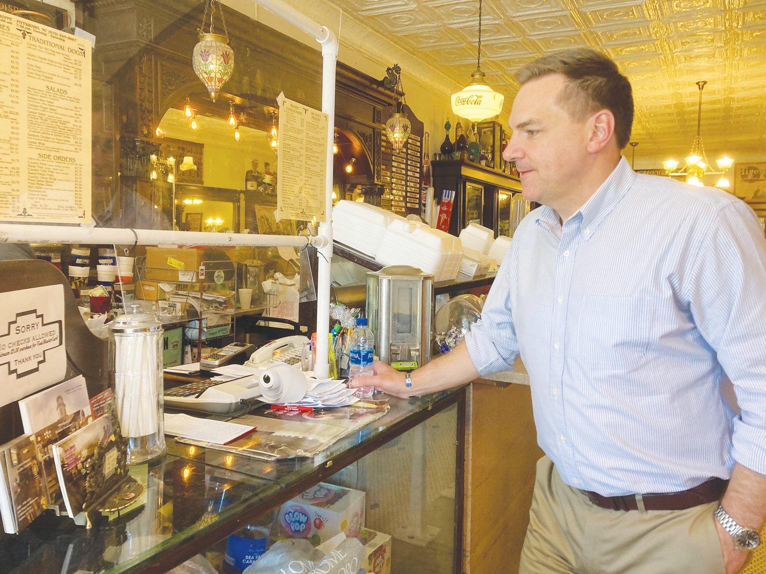 Congressman Richard Hudson Jr. stands at the counter of S&T's Soda Shoppe in downtown Pittsboro.