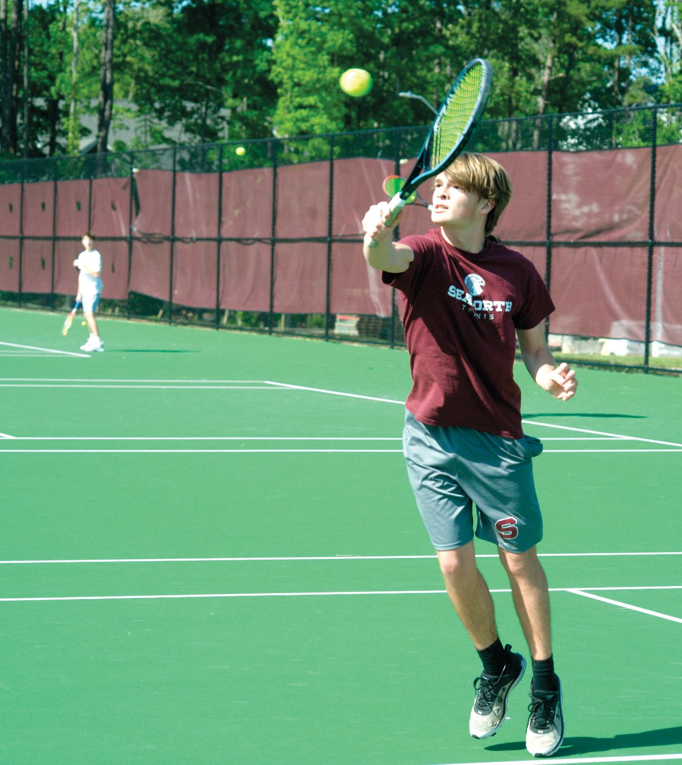 Seaforth No. 2 singles player, junior Felton Burleigh, outstretches for a nice backhanded return during the Hawks' 8-1 loss to the Raleigh Charter Phoenix on April 27. Burleigh lost his singles match to Phoenix senior Alex Hong, 2-6, 0-6.