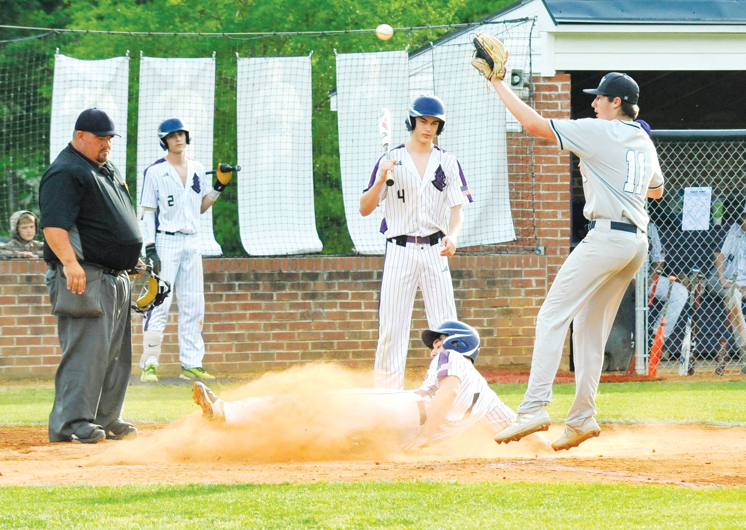 Chatham Charter sophomore Lucas Smith (1) slides into home plate to account for 1 of the 16 runs scored by the Knights in the 15-run thrashing of the Ascend Leadership Aviators on April 26.
