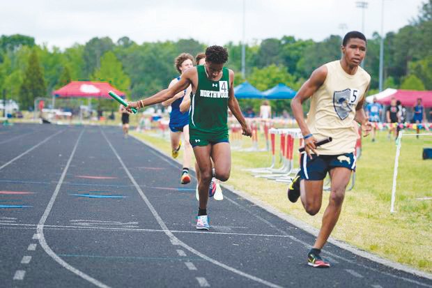 Northwood junior Christian Glick (4) takes the baton during one of the men's relay events at the NCHSAA 3A Mideast Regionals at Franklinton High School last Saturday. Glick is a member of two state-qualifying relay teams, including the men's 4x400- and the 4x800-meter relays.