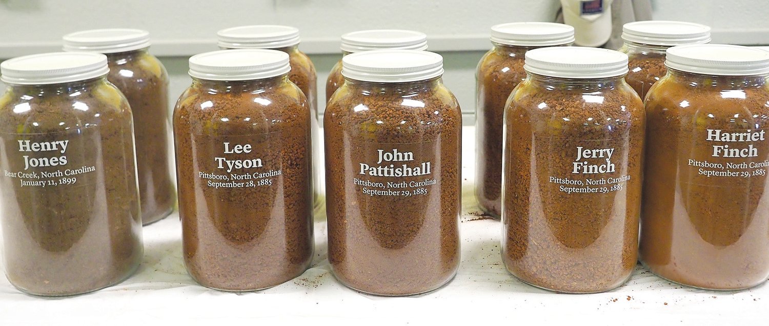 Jars filled with soil from the lynching sites of the five victims memorialized Saturday in Pittsboro.