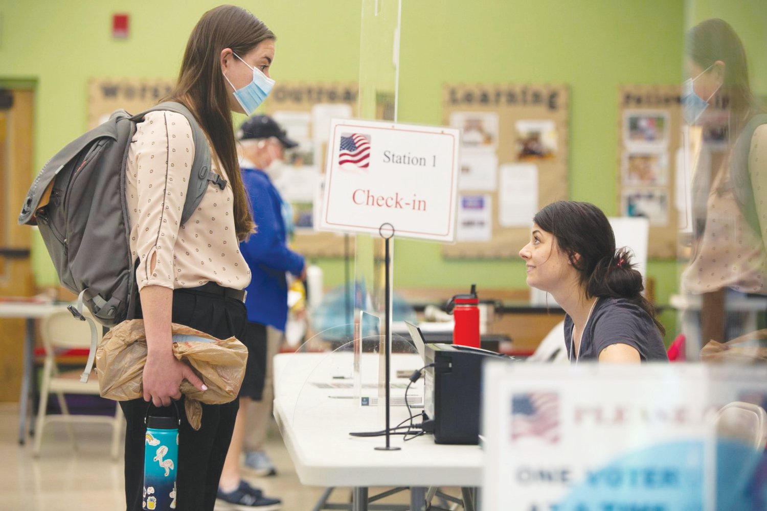 Buncombe County poll worker Rachel Naso checks in Catherine Perez for primary voting on May 17 at the St. Mark’s Lutheran Church polling place in Asheville.