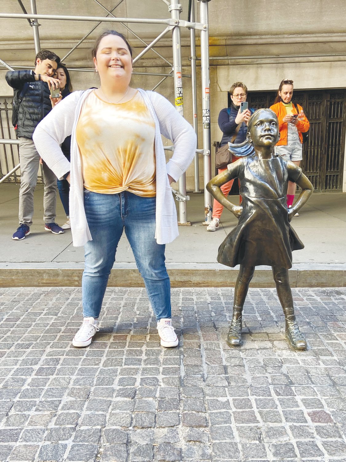 Laci Burt poses with the inspiring and popular 'Fearless Girl' statue on Wall Street.
