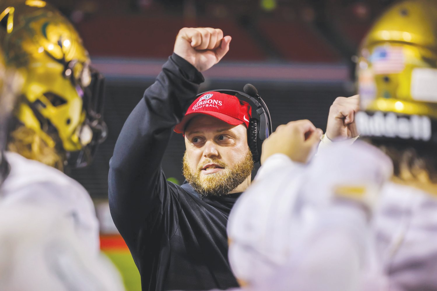 Cardinal Gibbons' special teams coordinator Josh Proctor (center), raises a fist, signifying fourth down, on the sideline of a Crusaders game during his three-year stint with the program from 2019-21. Proctor was hired to be the tight ends coach at IMG Academy in May.