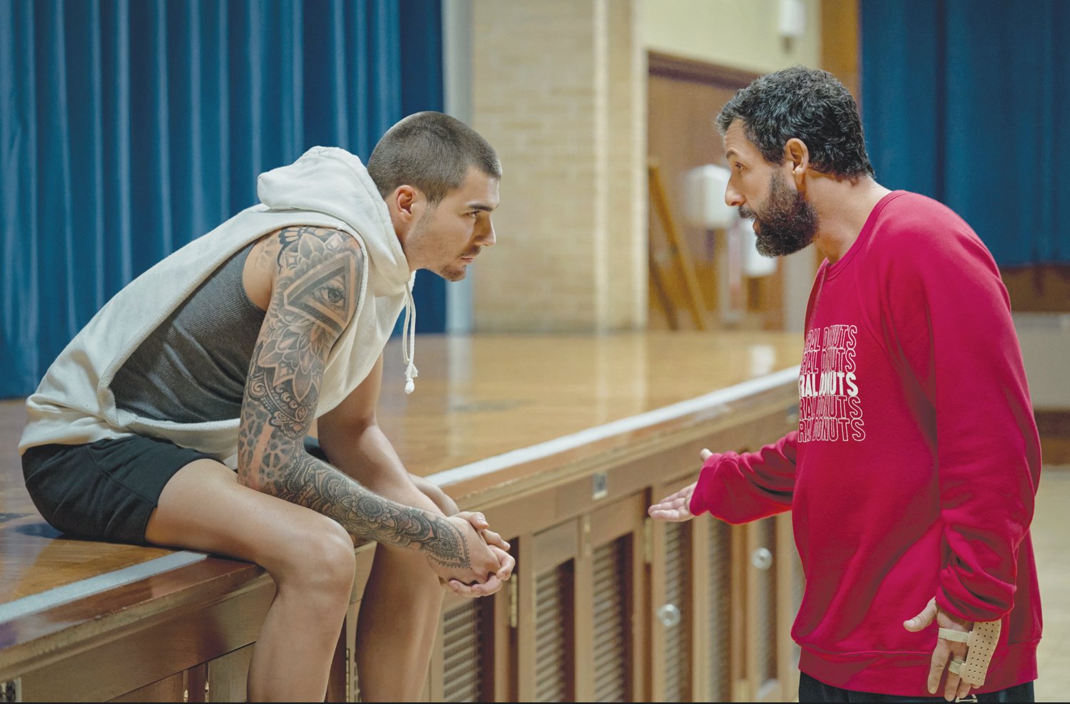 NBA power forward Juancho Hernangomez (left) and Adam Sandler team up as a player-scout duo in Netflix's 2022 film 'Hustle.'