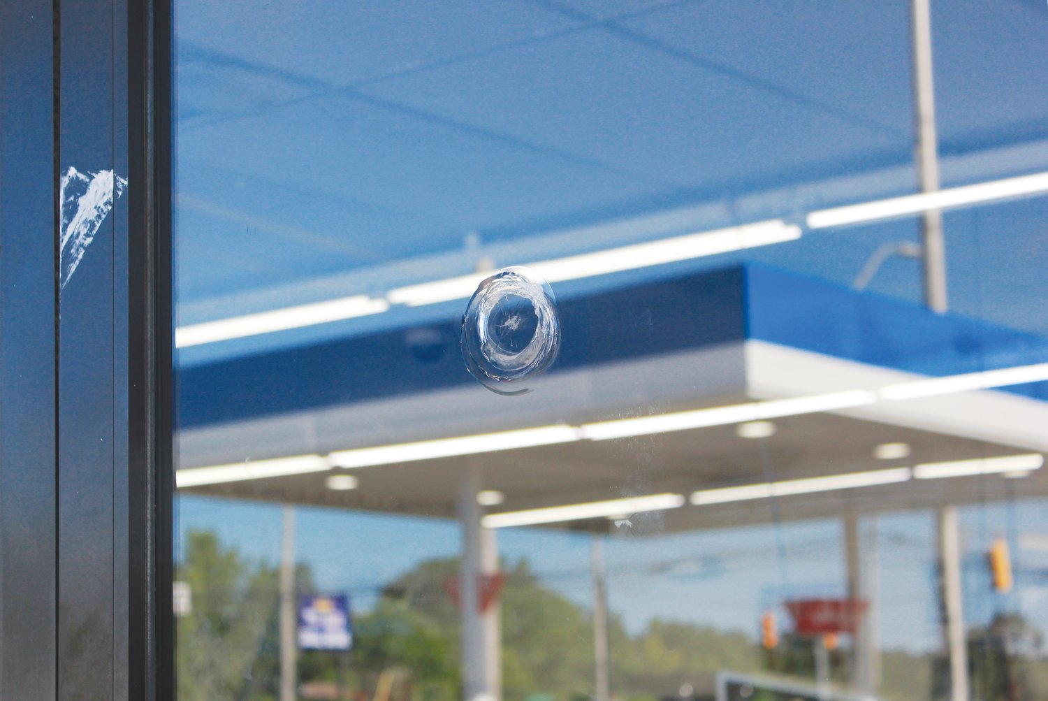 The glass door of the Park ’n Shop gas station is marked by a bullet hole from the shooting that occurred July 9 in Siler City. According to the SCPD, the shooting is still under investigation and charges are pending.