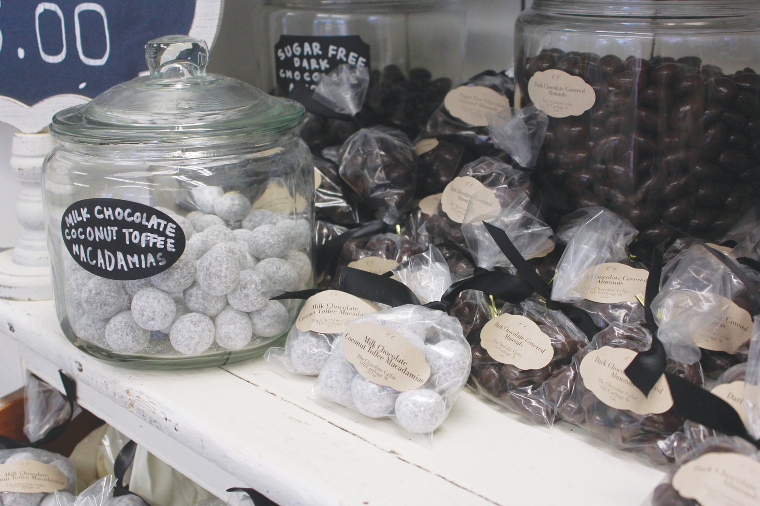 Chocolate covered nuts of various kinds line the shelves inside Chocolate Cellar Deux.