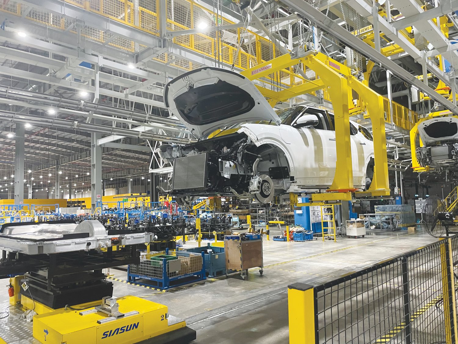 A look inside the VF-9 SUV as it travels down VinFast's assembly line in Haiphong. VinFast says it is preparing to scale production to send the VF-9 to mass market by September. The electric vehicle will be one of two cars to be manufactured when VinFast's plant opens in Chatham County in 2024.