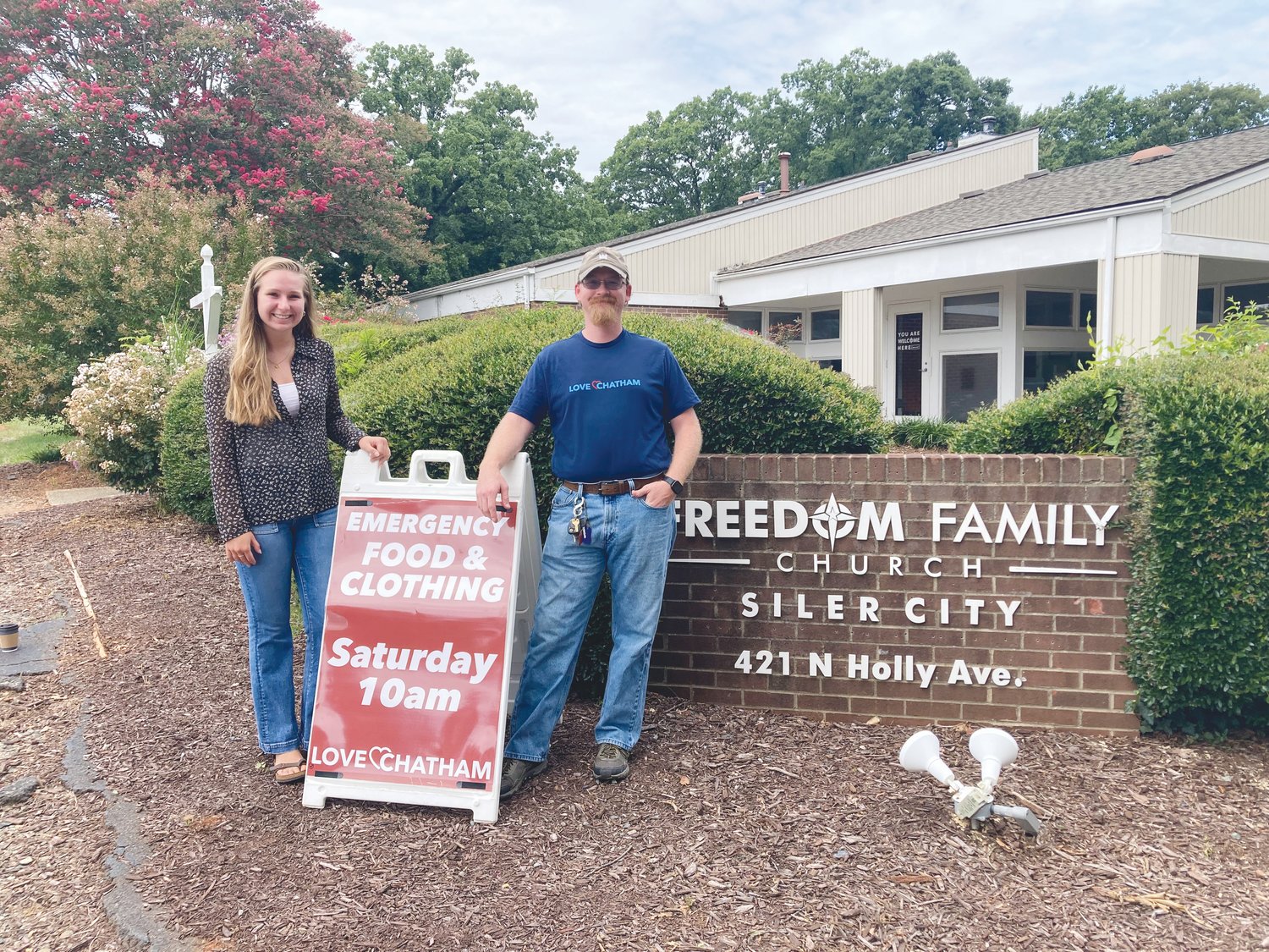 Love Chatham intern Mary Lacey Eubanks (left) and Dakota Philbrick, the nonprofit's executive director, stand in front of Freedom Family Church in Siler City, where Love Chatham is headquartered.