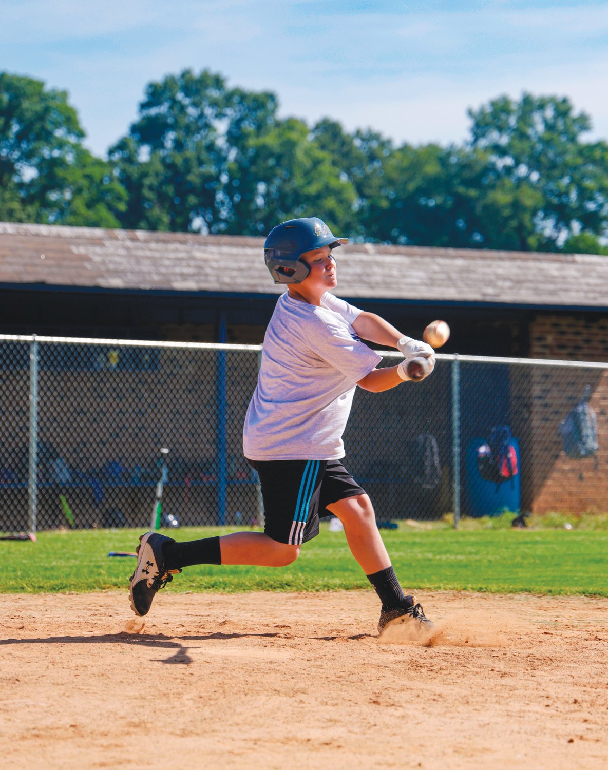 Jackson, a camper at Jordan-Matthews' annual baseball camp, swings at a pitch during the scrimmage portion of camp.