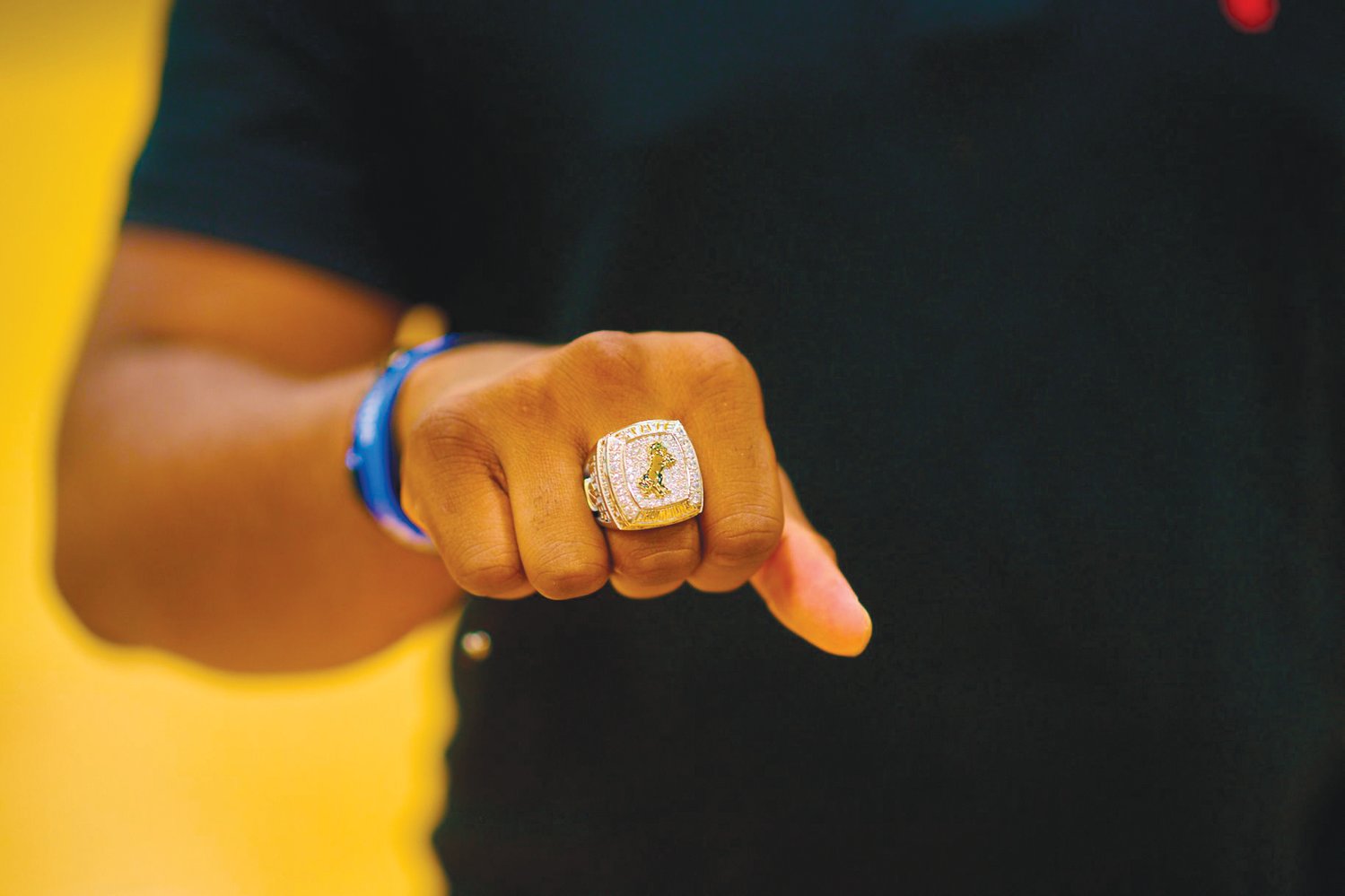 A closeup of the ring shows the Northwood Chargers logo rearing its head centered on a glimmering field of gems.