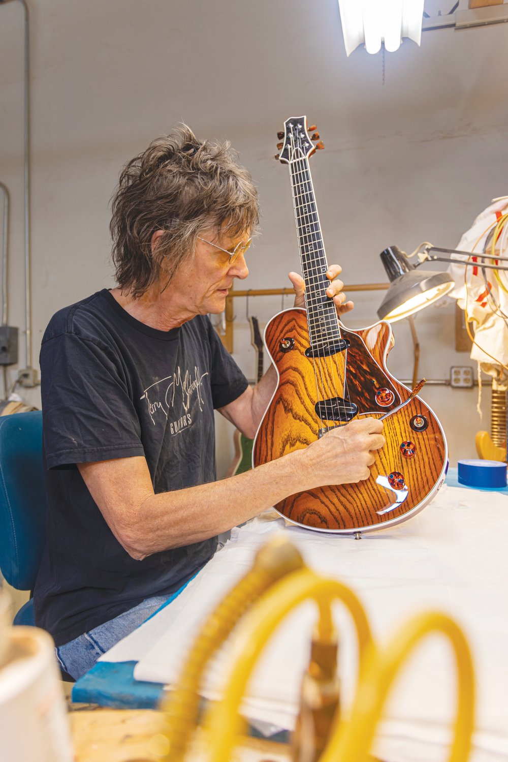 Terry McInturff, who's built guitars for some of rock's luminaries, poses with a new creation. The Koo Day Tah event, which, in part, honors his birthday, is set for Saturday in Siler City.