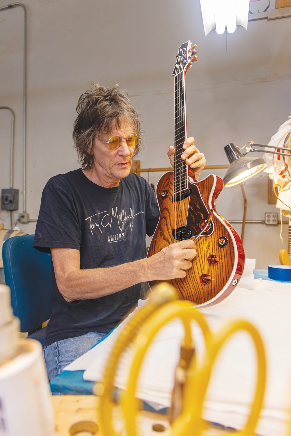 Terry McInturff, who's built guitars for some of rock's luminaries, poses with a new creation. The Koo Day Tah event, which, in part, honors his birthday, is set for Saturday in Siler City.