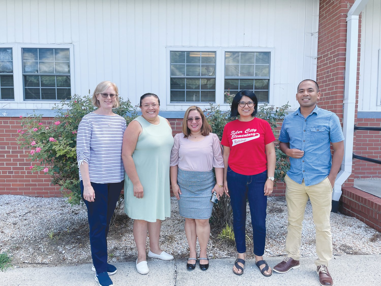 International Teacher Coach JoAnna Massoth (left) poses with Chatham County Schools international teachers Shirley Rojas, Jacqueline Aguiluz, Sandra Rincon and Francis Salmazan in front of the CCS administrative office in Pittsboro.
