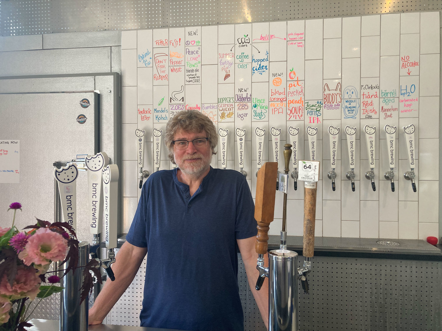 John Rice stands in bmc brewing's taproom, where the Peace, Love, Paws Blonde Ale is available for purchase.