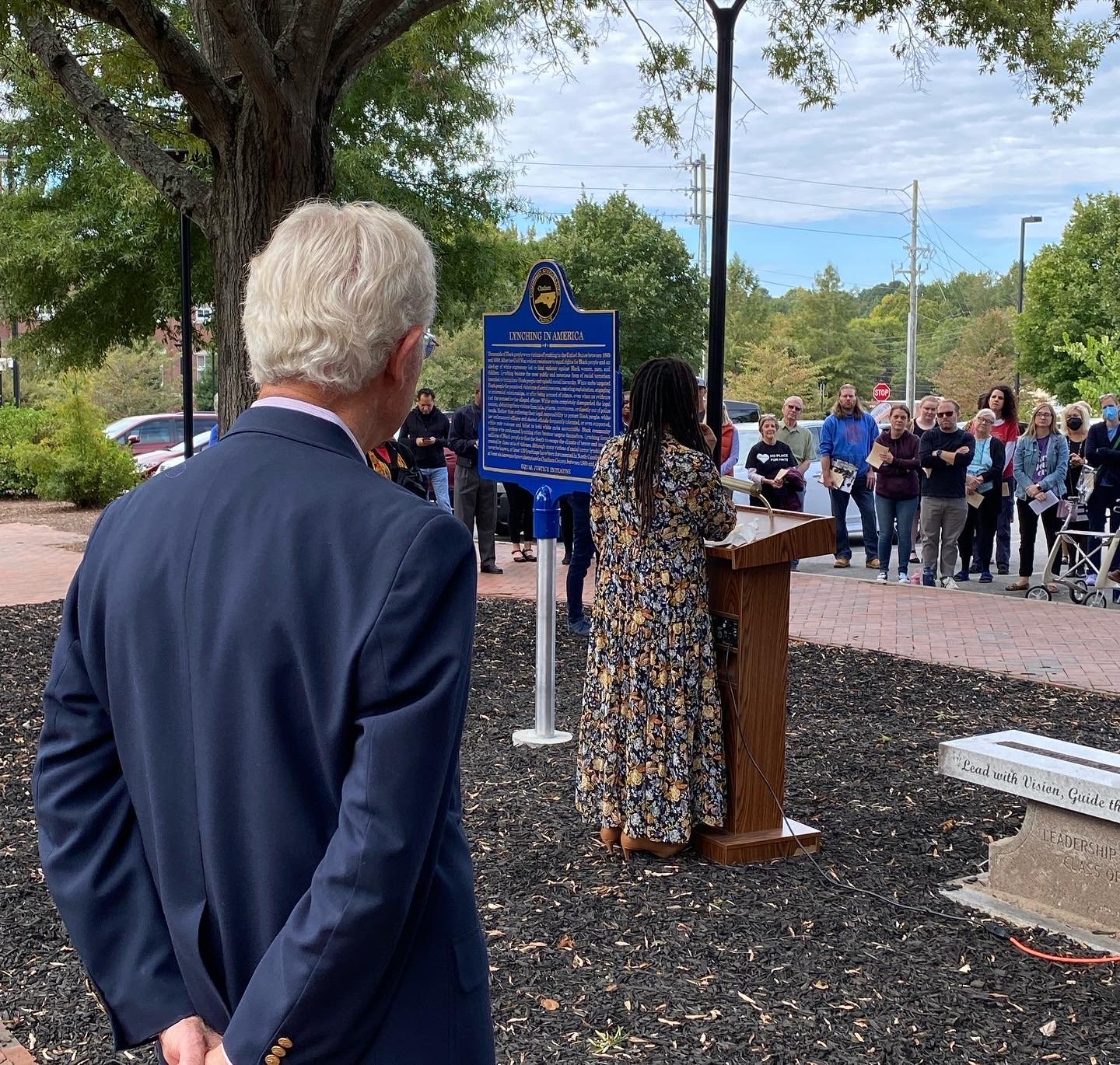 Bob Pearson of Pittsboro, who helped organize CRC-C and led the effort to place the memorial marker, watches as Chatham County Commissioner Karen Howard receives it on behalf of the county.