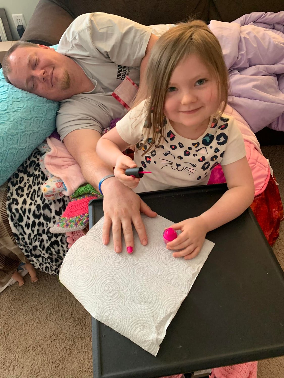 Kenzie Scoggins, 5, paints her father Dusty's nails. Kenzie loved doing makeovers and painting nails.