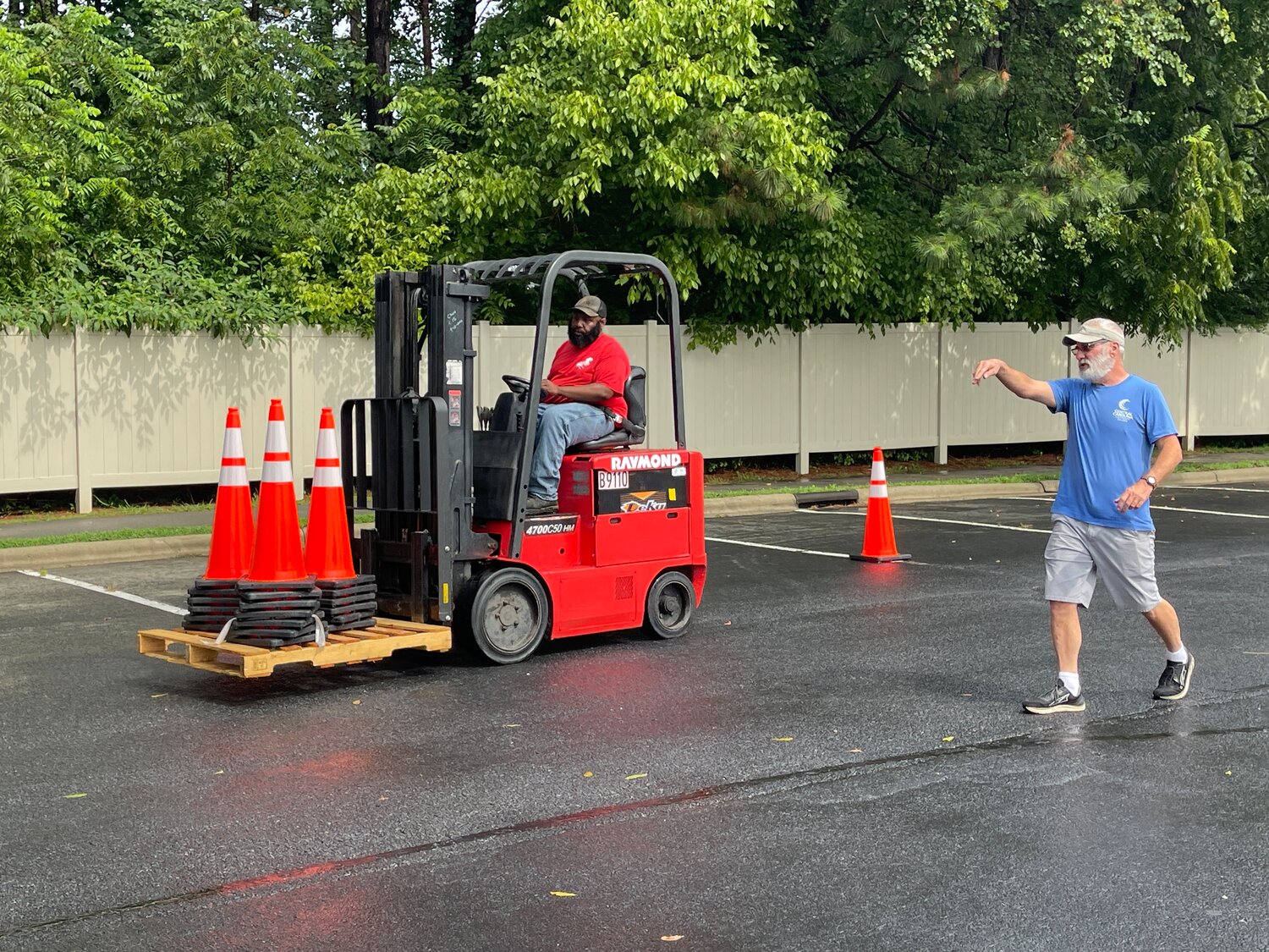 A student zigzags through traffic cones, bringing the forklift back to its initial spot as Rankin helps him through.